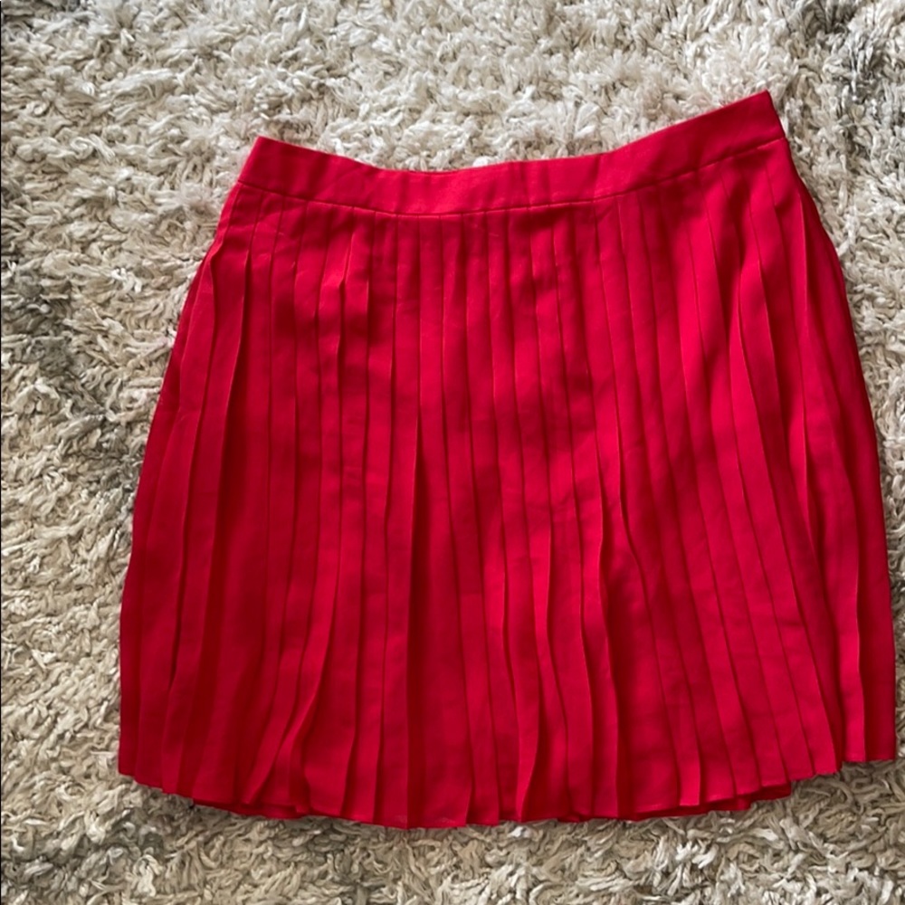 Red pleated mini skirt